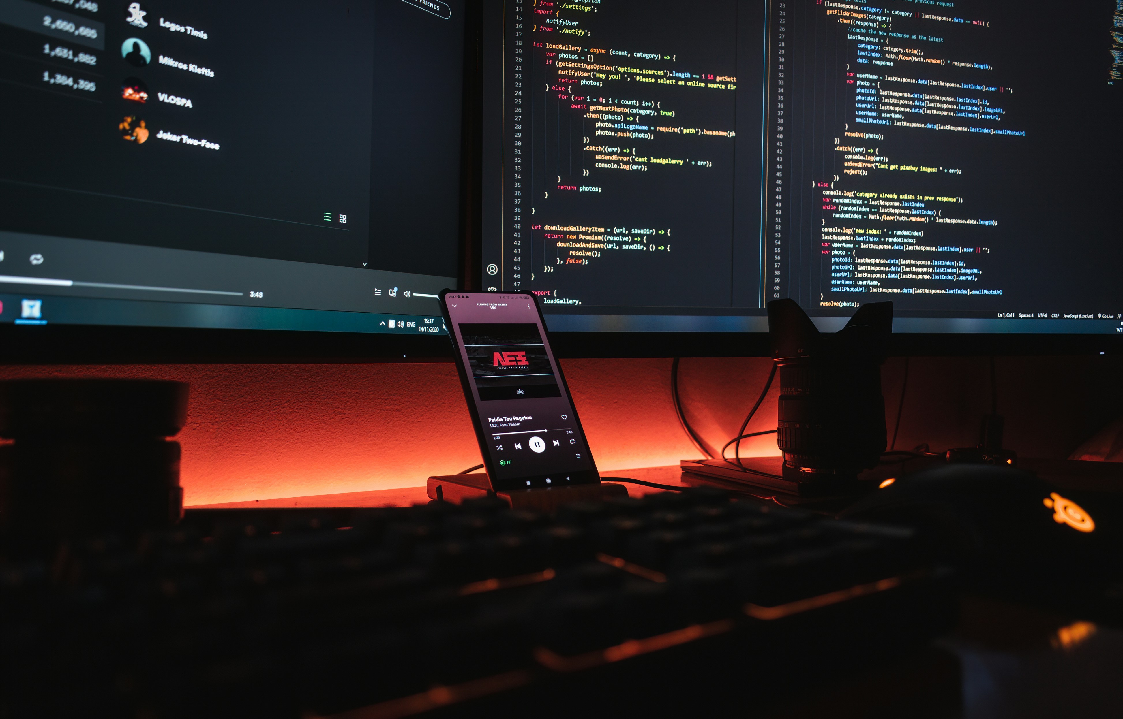 Professional developer with dual monitors showing complex code — custom web development